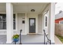 Inviting front porch with modern railing, decorative planters, and a stylish front door at 1041 S State Ave, Indianapolis, IN 46203