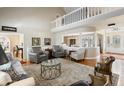 Open-concept living room with hardwood floors, a comfortable seating arrangement, and ample natural light at 113 Edgewater Dr, Noblesville, IN 46062