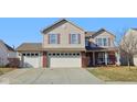 Charming two-story home with a three-car garage and well-maintained front yard on a sunny day at 11624 Eldridge Dr, Indianapolis, IN 46235