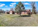 A single-story brick home featuring a well-maintained lawn and mature tree at 12 Danridge Dr, Danville, IN 46122