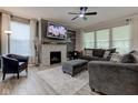 Cozy living room with a fireplace, plush seating, and large windows at 12073 Springtide Ln, Fishers, IN 46037