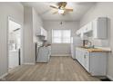 Bright kitchen with white cabinets, laminate countertops and vinyl floors at 1211 W 30Th St, Indianapolis, IN 46208