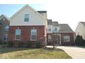 Charming two-story home with a brick and vinyl facade, driveway and well-maintained lawn at 12387 Wolverton Way, Fishers, IN 46037