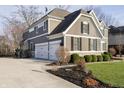 Side view of a two-story house with a three-car garage and neutral paint, showcasing its architecture at 12433 Harvest Glen Blvd, Fishers, IN 46037