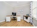 Home office featuring a desk, chair, decor and wood floors, bathed in natural light from a window at 12433 Harvest Glen Blvd, Fishers, IN 46037