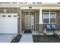 Inviting front porch with brick columns, seating, and a view of the manicured front yard at 1399 Hat Band St, Danville, IN 46122