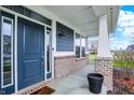 Inviting front porch featuring a stylish door, brick accents, and ample natural light at 15831 Eastpark Dr, Noblesville, IN 46060
