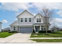 Charming two-story home boasts a well-kept lawn, stylish siding, and an attached two-car garage at 16753 Workington Way, Westfield, IN 46074