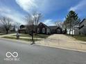 Charming brick home with a long driveway and attached two car garage at 1808 Turning Leaf Dr, Franklin, IN 46131