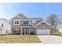Beautiful two-story house with gray siding, a brick accent, and a spacious two-car garage at 192 Lynnette Way, Indianapolis, IN 46229