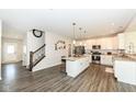 Bright, open kitchen featuring white cabinets, stainless steel appliances, and a large center island with seating at 192 Lynnette Way, Indianapolis, IN 46229