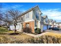Two-story townhouse with light siding, brick accents and an attached garage at 2255 Colfax Ln, Indianapolis, IN 46260