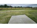 Wide-open backyard space perfect for relaxation with grass and the concrete slab for entertaining at 2290 Oakmont Dr, Plainfield, IN 46168