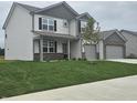 Attractive two-story home featuring a welcoming front porch, a spacious lawn, and a two-car garage at 2290 Oakmont Dr, Plainfield, IN 46168
