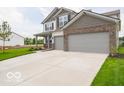 Attractive two-story home featuring brick accents, a wide driveway, and a well-kept lawn at 2290 Oakmont Dr, Plainfield, IN 46168