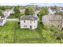Aerial view of home featuring a spacious backyard with well-kept lawn and black metal fence at 2992 Sentiment Ln, Greenwood, IN 46143