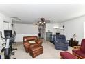 Bonus room with neutral walls, ceiling fans, and varied seating options at 2992 Sentiment Ln, Greenwood, IN 46143