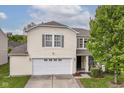Charming two-story home with a two-car garage and well-maintained lawn and green tree at 2992 Sentiment Ln, Greenwood, IN 46143