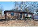 Cozy one-story brick house with tidy landscaping and a welcoming front door at 3813 N Hartman Dr, Indianapolis, IN 46226