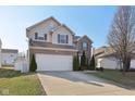 Attractive two-story home with a long driveway and brick and vinyl facade at 3832 Kilburn Ct, Indianapolis, IN 46228