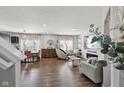 Open-concept living room with hardwood floors, a stone fireplace, and a modern design at 3832 Kilburn Ct, Indianapolis, IN 46228
