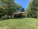The backyard has mature trees and a deck that adds a touch of outdoor living at 5515 Shorewood Dr, Indianapolis, IN 46220