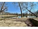 Scenic view of the pond featuring a wooden dock, clear water, and a backdrop of trees at 5850 Paradise Ln, Martinsville, IN 46151