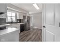 Bright kitchen with white cabinets, stainless steel appliances, and modern backsplash at 7089 W Us Highway 36, Danville, IN 46122