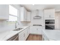 Bright kitchen with white cabinetry, stainless steel appliances, and a modern design at 8445 Morgan Ln, Zionsville, IN 46077