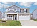 Charming two-story home with stone accents, a landscaped yard, and a spacious two car garage at 856 Parker Ln, Westfield, IN 46074