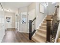 Welcoming foyer with wood floors, staircase, and elegant decor at 856 Parker Ln, Westfield, IN 46074