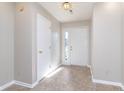 Bright foyer with a large front door with sidelight and tile flooring at 9930 Chinquapin Ct, Carmel, IN 46033