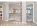Open-concept living area with neutral paint, new carpet, ceiling fan and natural light at 9930 Chinquapin Ct, Carmel, IN 46033