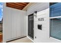 Inviting entrance with updated hardware, white siding, and clearly visible house number at 1020 Calvary St, Indianapolis, IN 46203