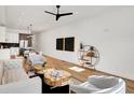 Open-concept living room with hardwood floors, stylish furniture, and views into the kitchen at 1020 Calvary St, Indianapolis, IN 46203
