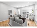 Open-concept living space with modern furnishings, hardwood floors, and seamless flow to kitchen at 1129 Church St, Indianapolis, IN 46225