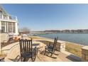 Outdoor patio with fire pit and seating overlooking the lake and marina at 12561 Marina View Dr, Indianapolis, IN 46256