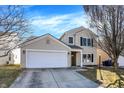 Attractive two-story home with a two-car garage, set against a bright blue sky, offers curb appeal at 12635 Braddock Ln, Noblesville, IN 46060