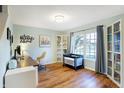 Bright home office featuring a large window, stylish décor, and hardwood floors, ideal for working from home at 12635 Braddock Ln, Noblesville, IN 46060