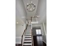 Staircase with decorative chandelier overhead at 13509 Dunes Dr, Carmel, IN 46032