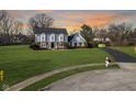 A sprawling two-story home with a well-kept lawn, a long driveway, and mature trees at 13813 Painter Ct, Carmel, IN 46032