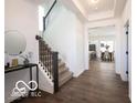 Bright entryway featuring beautiful hardwood floors and an elegant staircase leading to the upper level at 15304 Fairlands Dr, Westfield, IN 46074