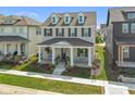 Beautifully landscaped front yard leading to a charming two-story home with a welcoming front porch at 15304 Fairlands Dr, Westfield, IN 46074