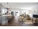 Open-concept living space features a modern kitchen, cozy fireplace, and a dining area at 15304 Fairlands Dr, Westfield, IN 46074