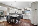 Modern kitchen with white cabinets, granite counters, and a central island at 1621 Rosebud Ln, Greenwood, IN 46143