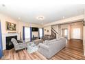 Cozy living room featuring a fireplace, hardwood floors, and lots of natural light at 16406 Taconite Dr, Noblesville, IN 46060