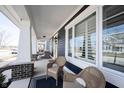 Cozy front porch featuring wicker chairs, a neutral rug, and white columns, offering a relaxing outdoor space at 1671 Avondale Dr, Westfield, IN 46074