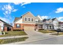 Charming two-story home with a brick and siding exterior, attached garage, and neatly manicured front lawn at 16736 Workington Way, Westfield, IN 46074