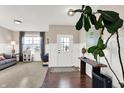 Bright foyer featuring hardwood floors, paneled walls, and a decorative console table with a large plant at 16736 Workington Way, Westfield, IN 46074
