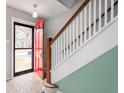 View of front door and stairs with a white banister and wood handrail at 1711 Kessler E Blvd, Indianapolis, IN 46220